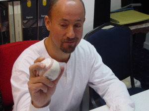 Alatheia client holds a baseball with his thumb prosthesis